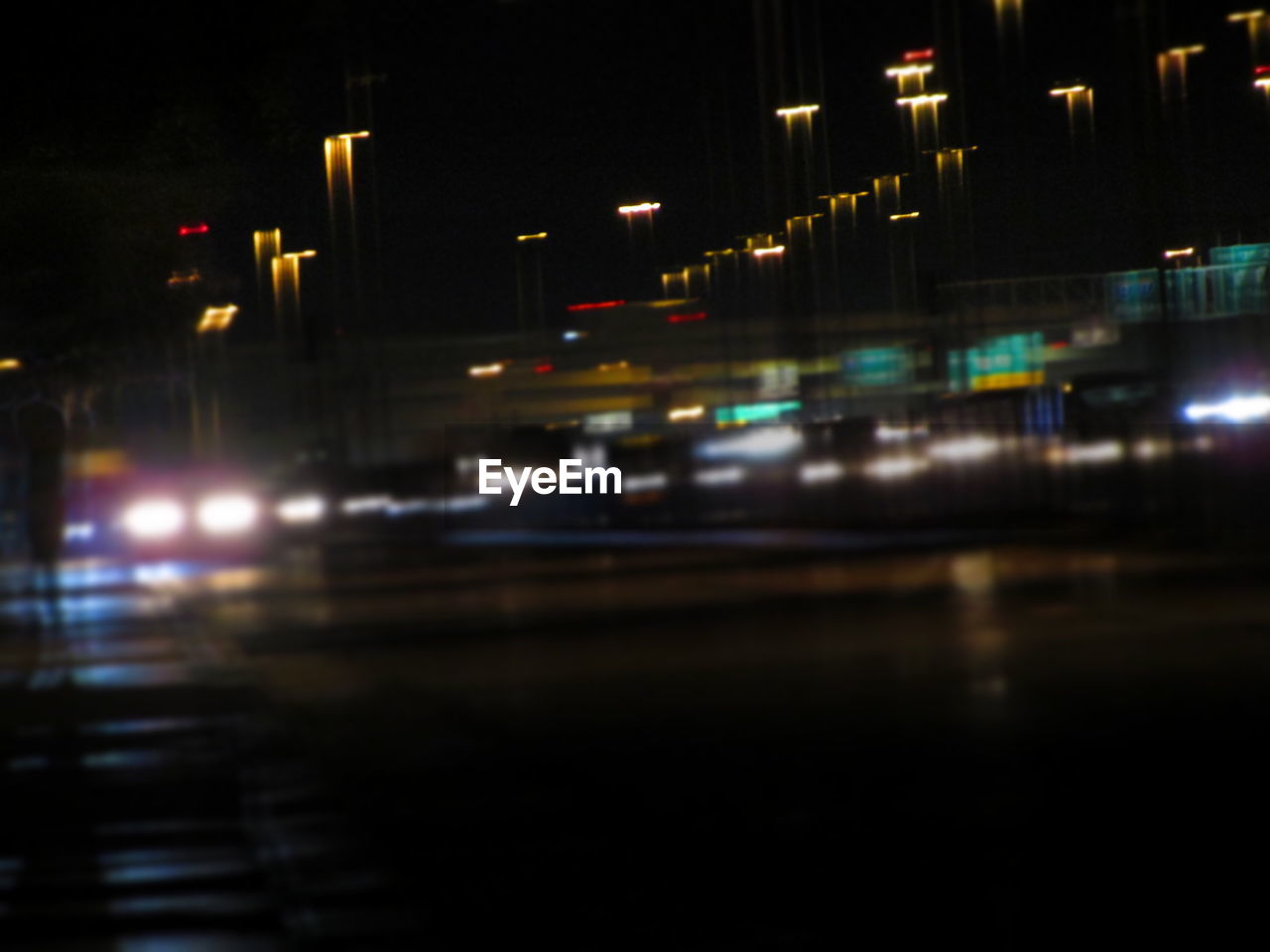 LIGHT TRAILS ON ROAD AT NIGHT