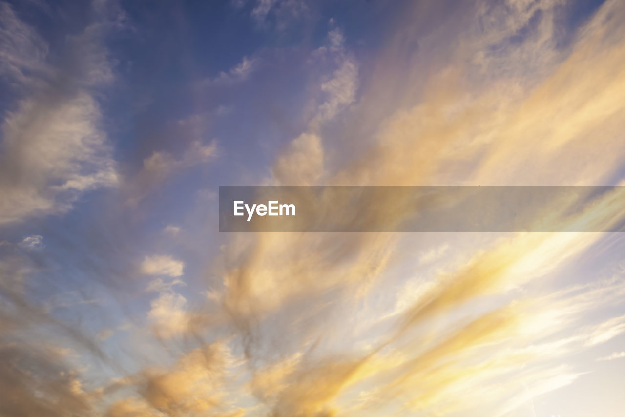 sky, cloud, sunset, dramatic sky, beauty in nature, backgrounds, nature, cloudscape, sunlight, scenics - nature, no people, tranquility, afterglow, environment, low angle view, blue, idyllic, moody sky, outdoors, atmosphere, tranquil scene, horizon, yellow, red sky at morning, multi colored, evening, orange color, awe, abstract, vibrant color, daytime, twilight, overcast, dusk, wind, copy space
