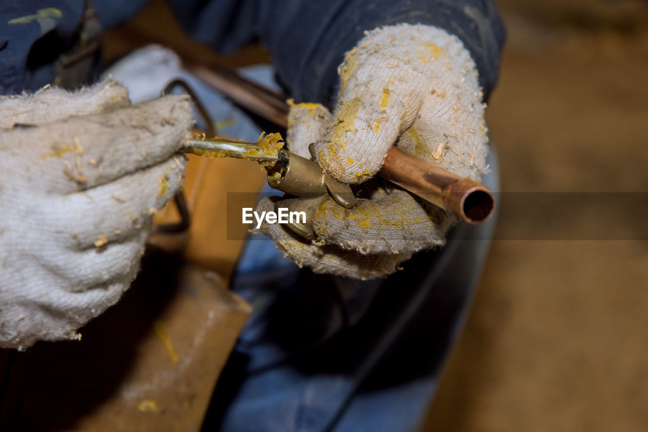 HIGH ANGLE VIEW OF MAN WORKING IN CONTAINER