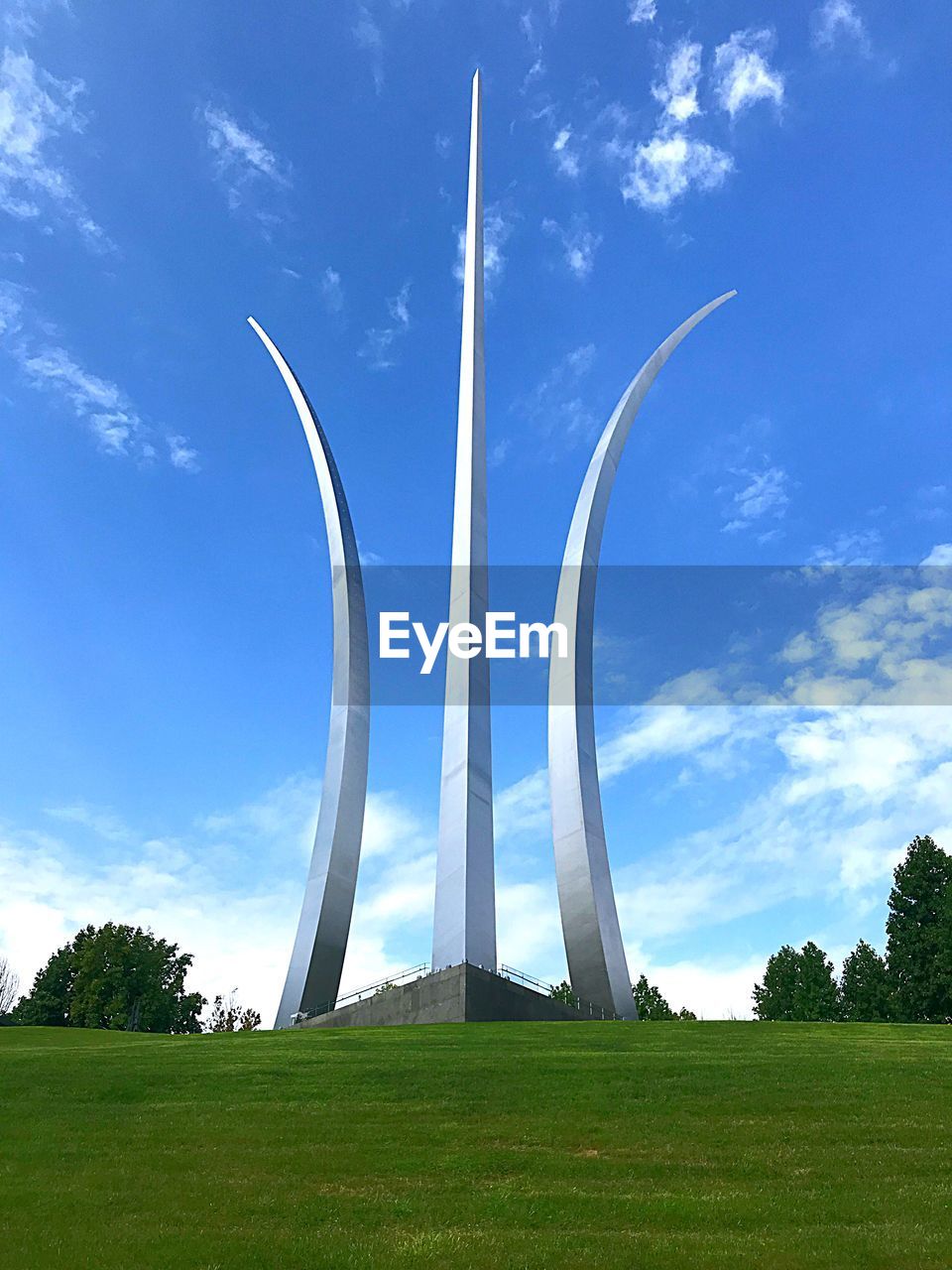 LOW ANGLE VIEW OF WIND TURBINES ON FIELD AGAINST SKY