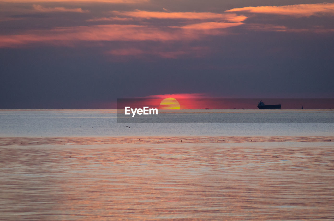 Scenic view of sea at sunset