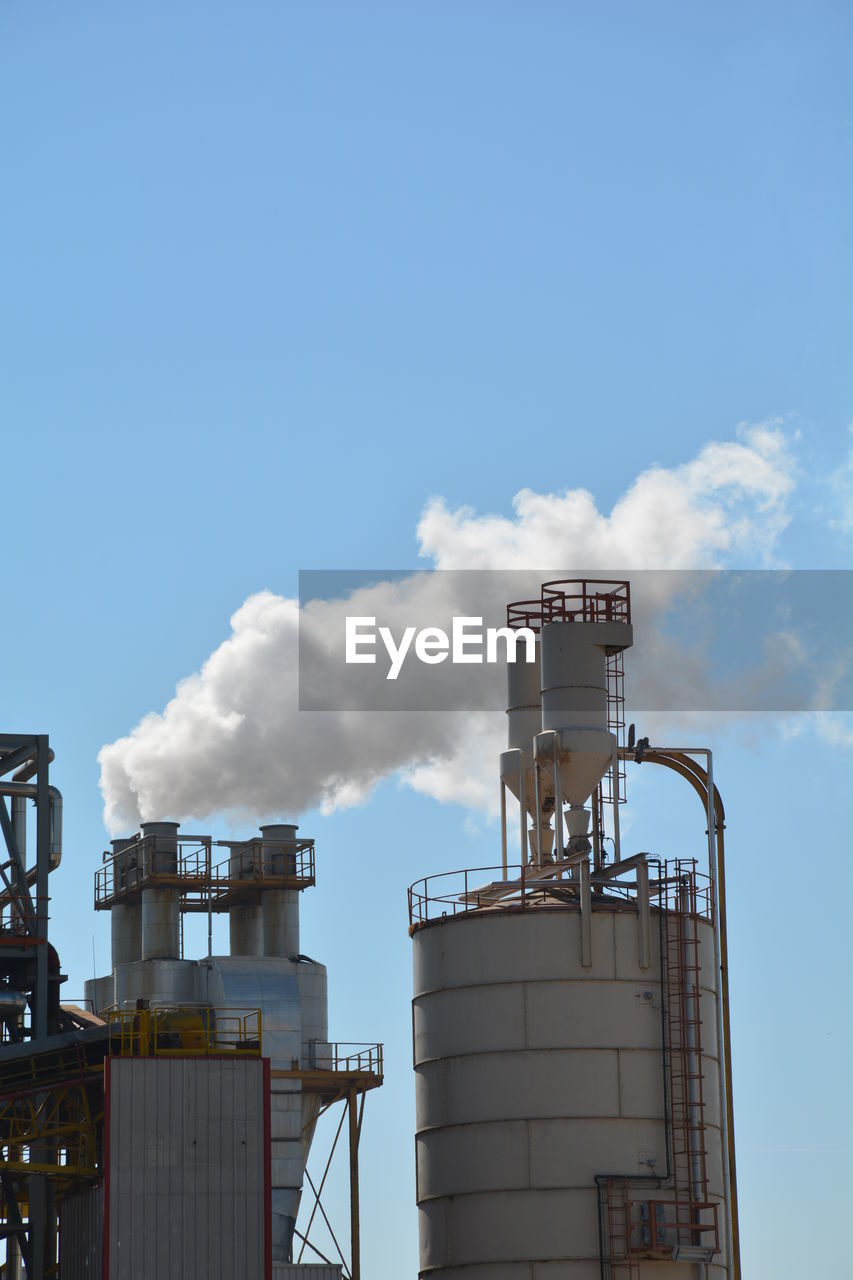 Low angle view of factory against sky