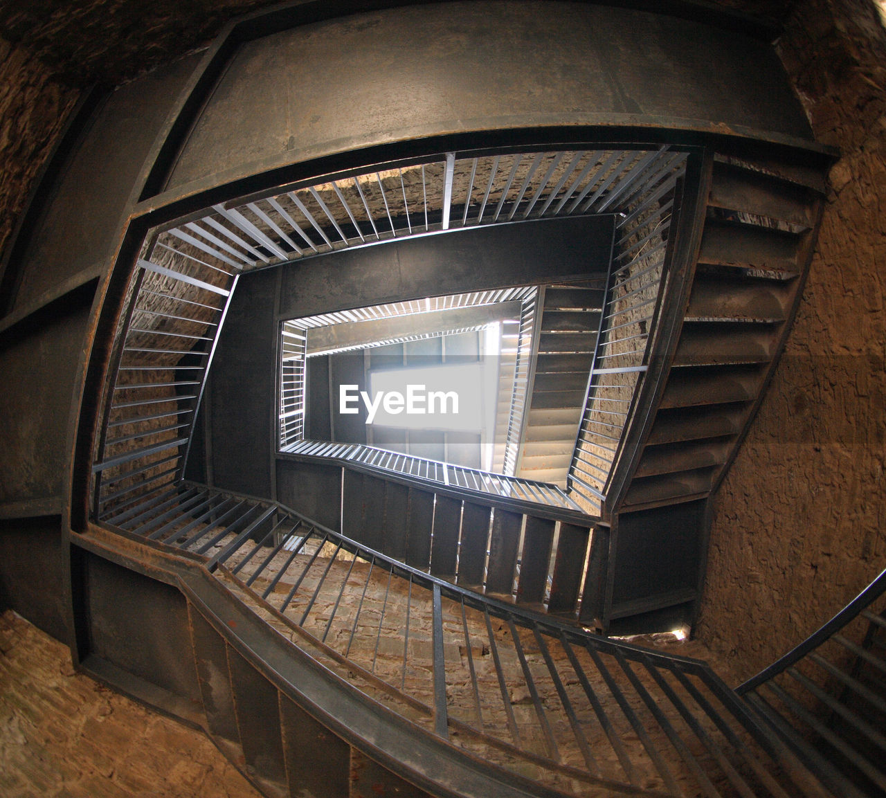 DIRECTLY BELOW SHOT OF SPIRAL STAIRCASE IN BUILDING