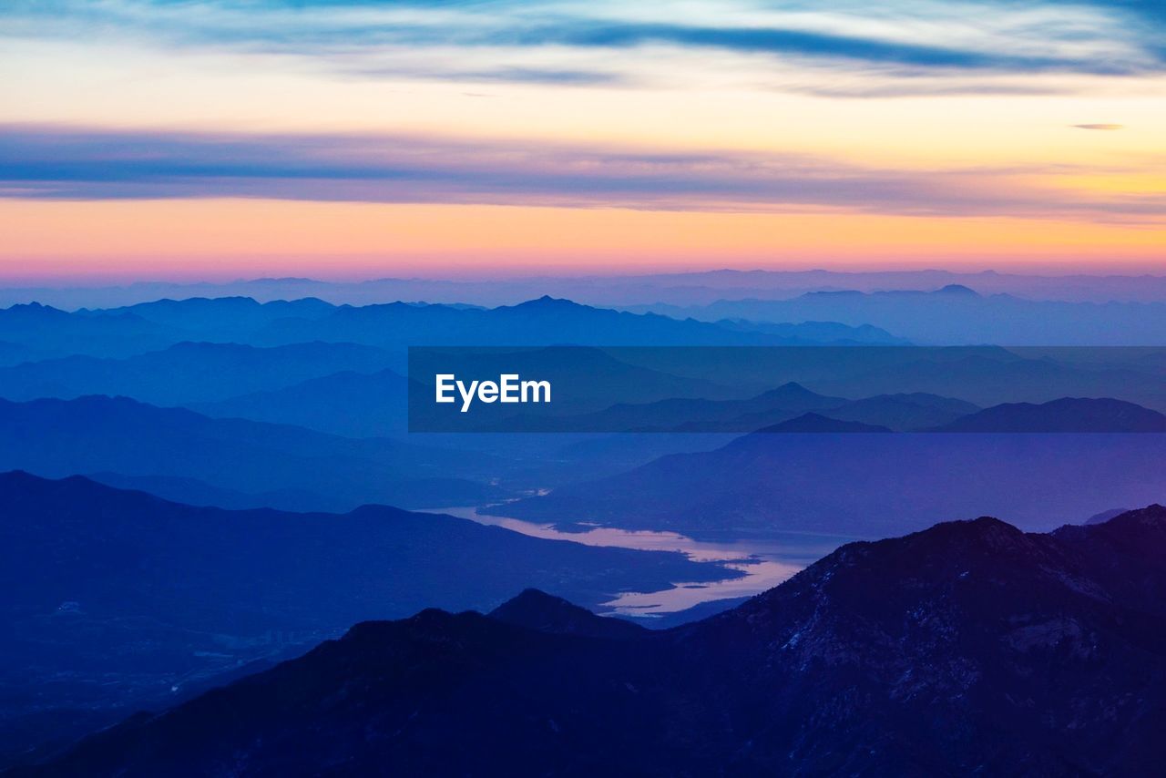 Scenic view of silhouette mountains against sky during sunset