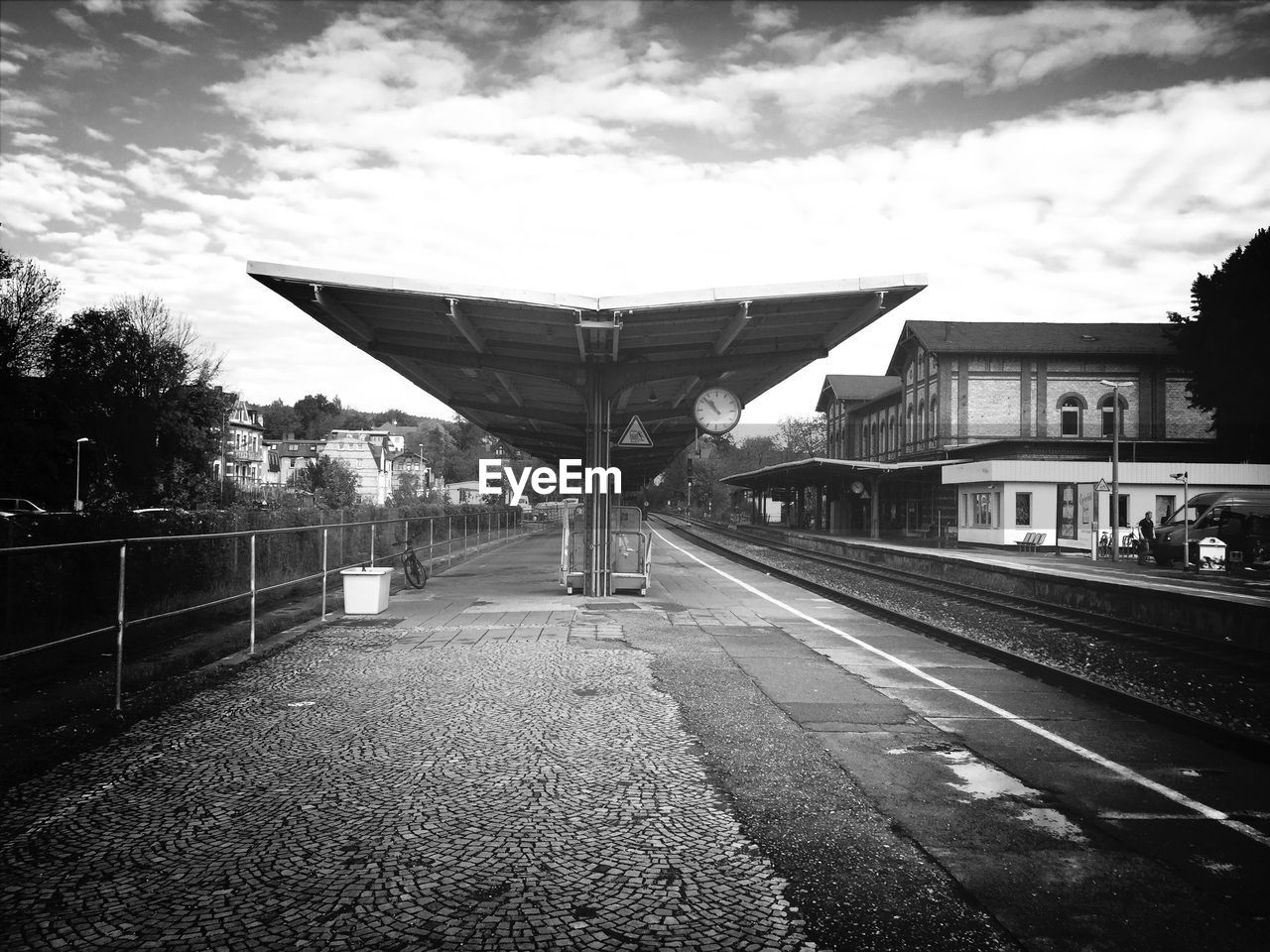 Empty railroad station platform against sky
