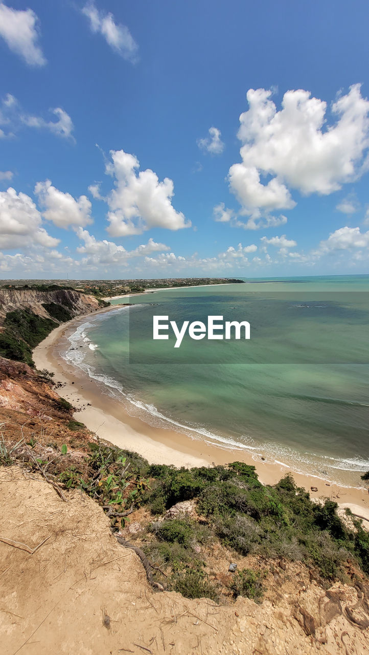 land, sea, water, sky, beach, cloud, scenics - nature, body of water, coast, nature, sand, beauty in nature, environment, shore, ocean, landscape, travel destinations, travel, coastline, blue, tourism, tranquility, vacation, holiday, no people, trip, wave, outdoors, tranquil scene, day, horizon, water's edge, horizon over water, bay, motion, cliff, sports, tropical climate, terrain, summer, plant, tree, island, seascape, non-urban scene, idyllic, water sports, cloudscape, sunny
