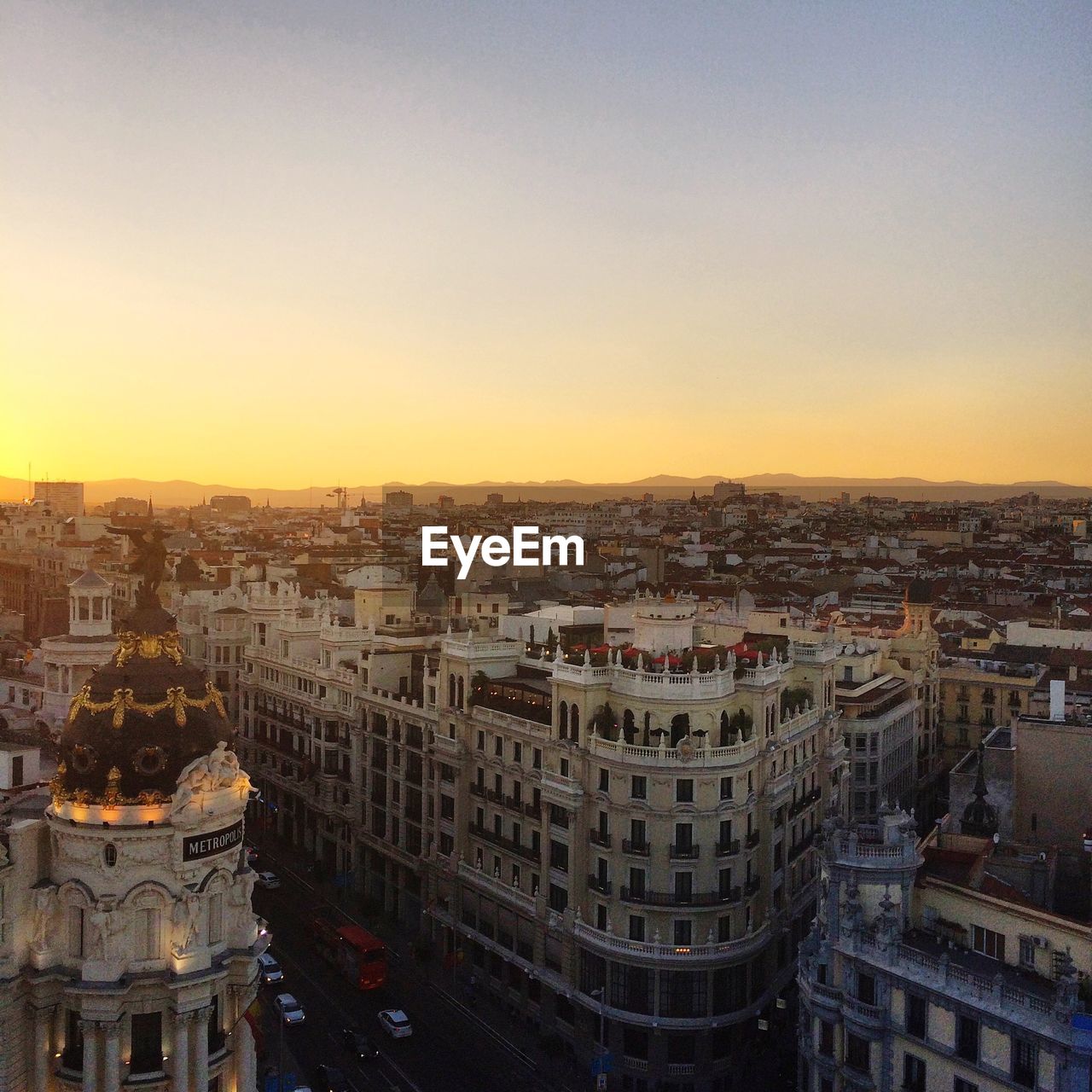 High angle view of city buildings against sky during sunset