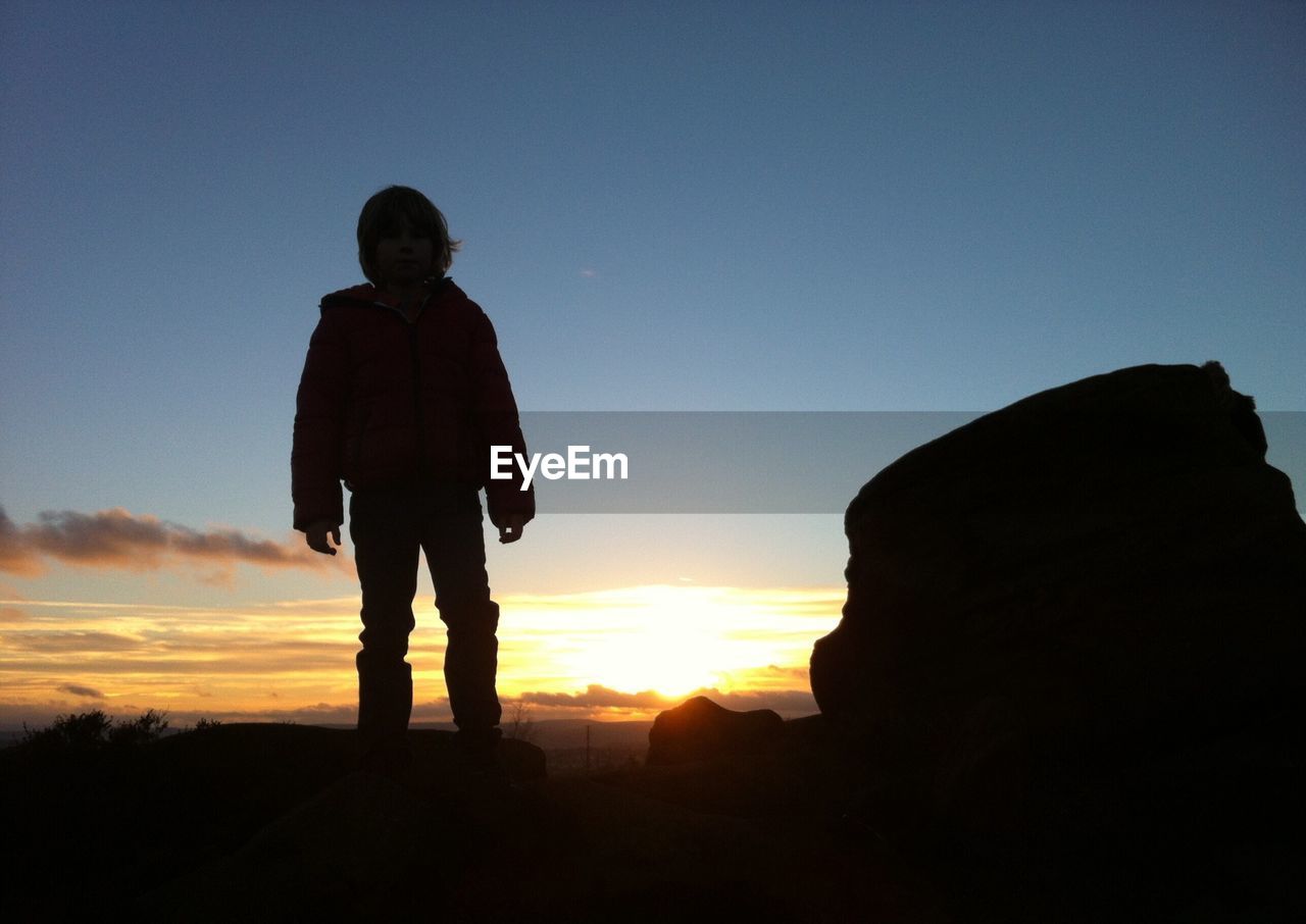 Silhouette of child against sunset