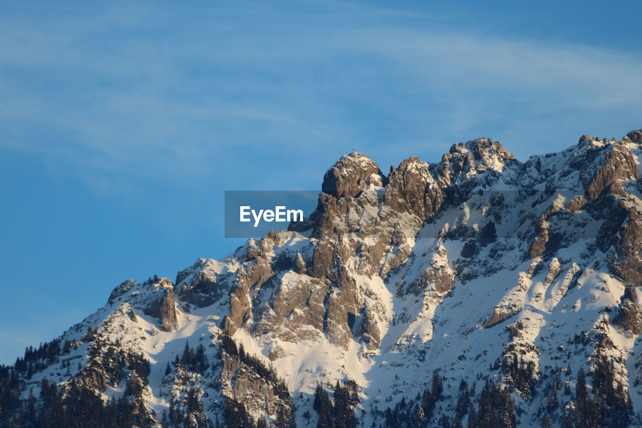 Panoramic view of snowcapped mountains against sky