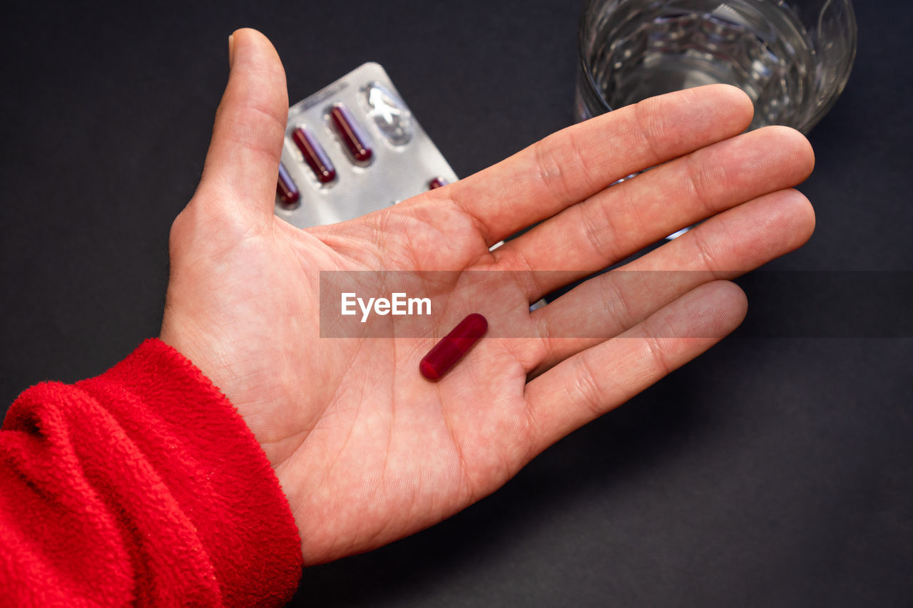 cropped hand of woman holding condom