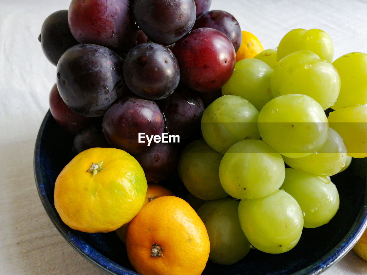 food and drink, food, healthy eating, fruit, wellbeing, freshness, grape, plant, produce, bowl, still life, no people, citrus fruit, large group of objects, indoors, abundance, table, organic, plate, household equipment, close-up, juicy, olive