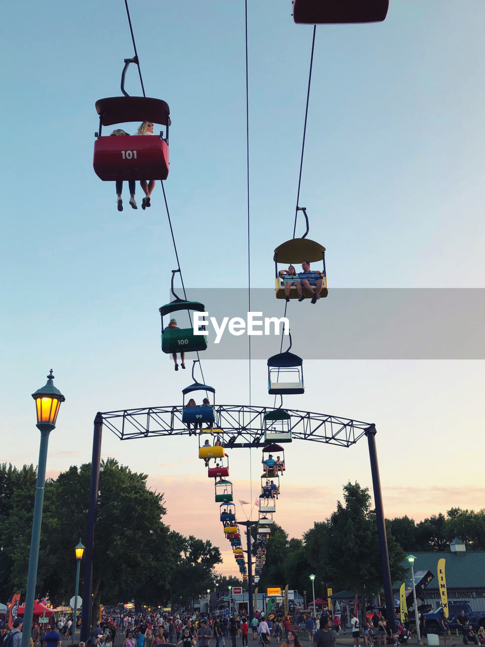 LOW ANGLE VIEW OF OVERHEAD CABLE CAR AGAINST SKY DURING SUNSET