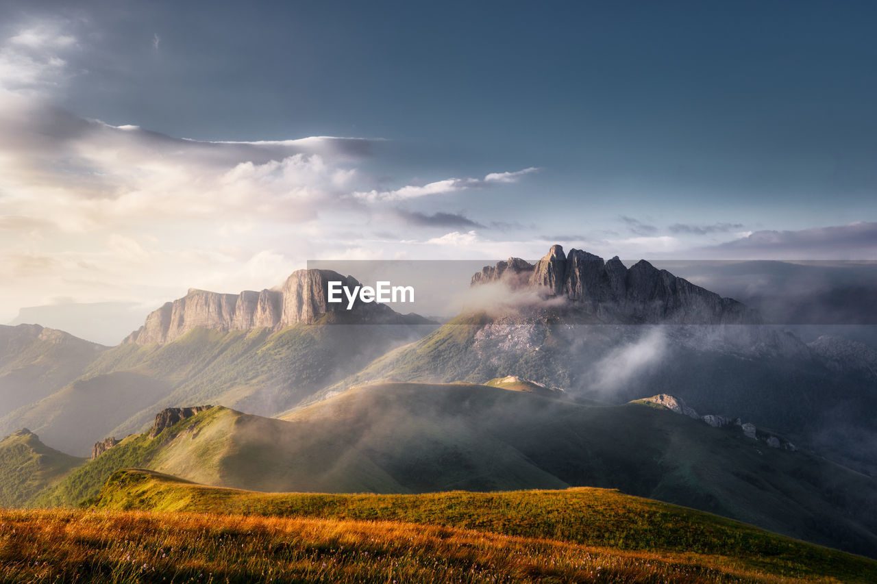 Mountain valley during bright sunrise in the fog. beautiful natural landscape. russia