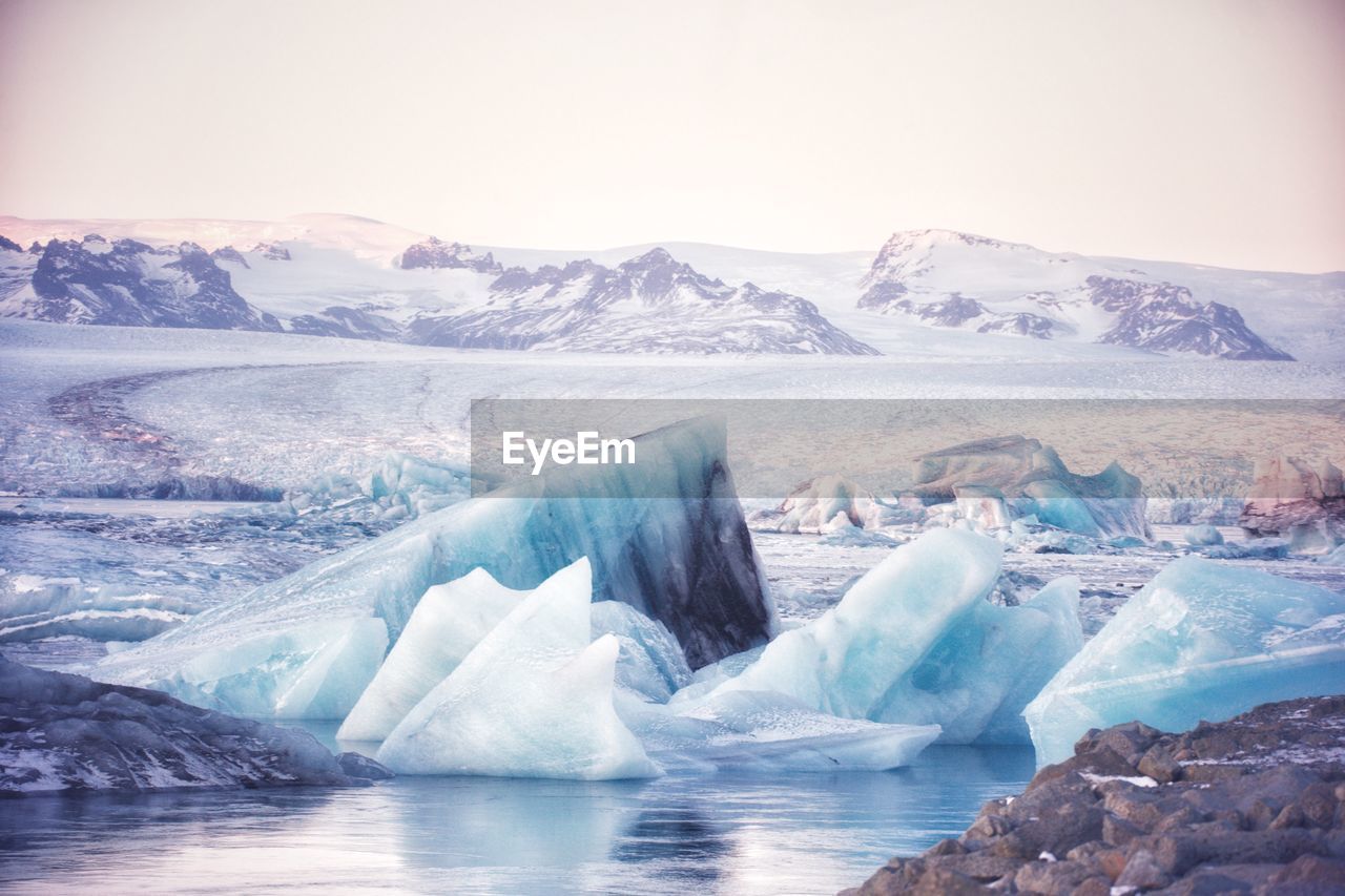 Icebergs in sea against sky