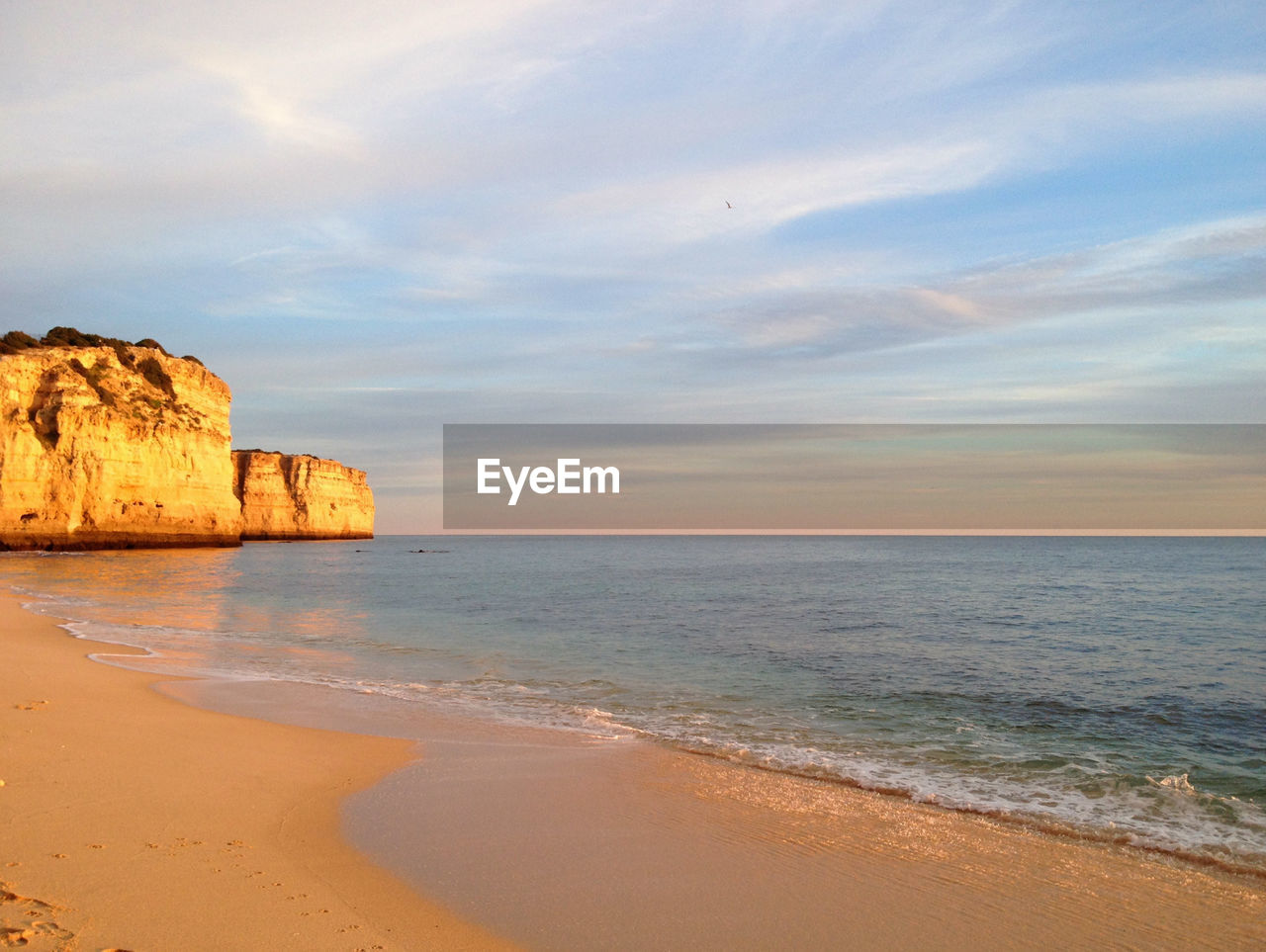 View of beach against cloudy sky