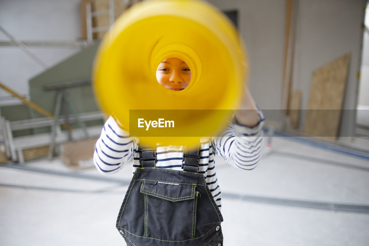 Portrait of boy looking through pipe