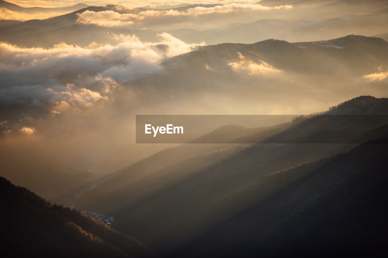 SCENIC VIEW OF MOUNTAIN AGAINST SKY DURING SUNSET