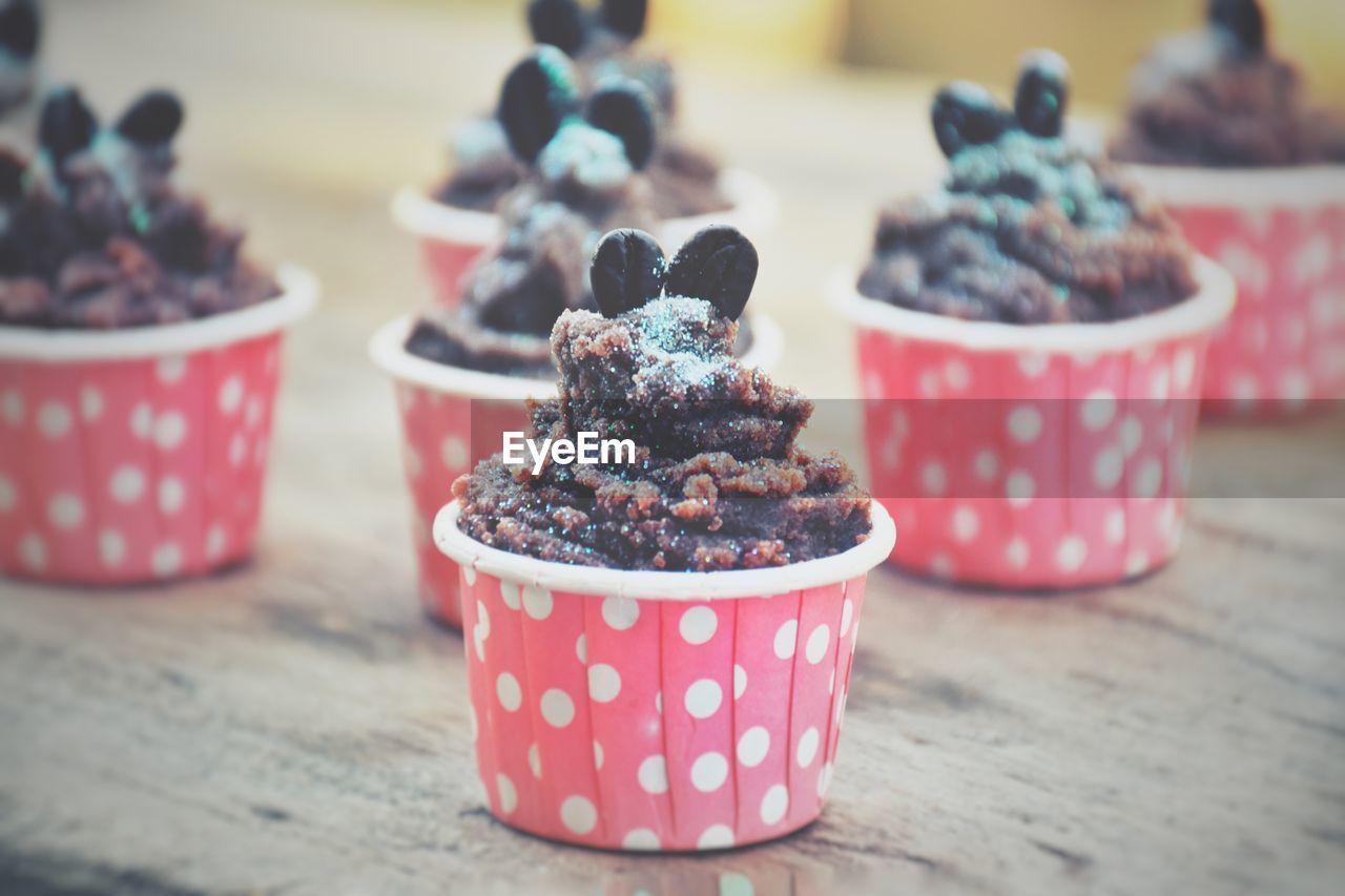 CLOSE-UP OF ICE CREAM WITH SPOON AND TABLE