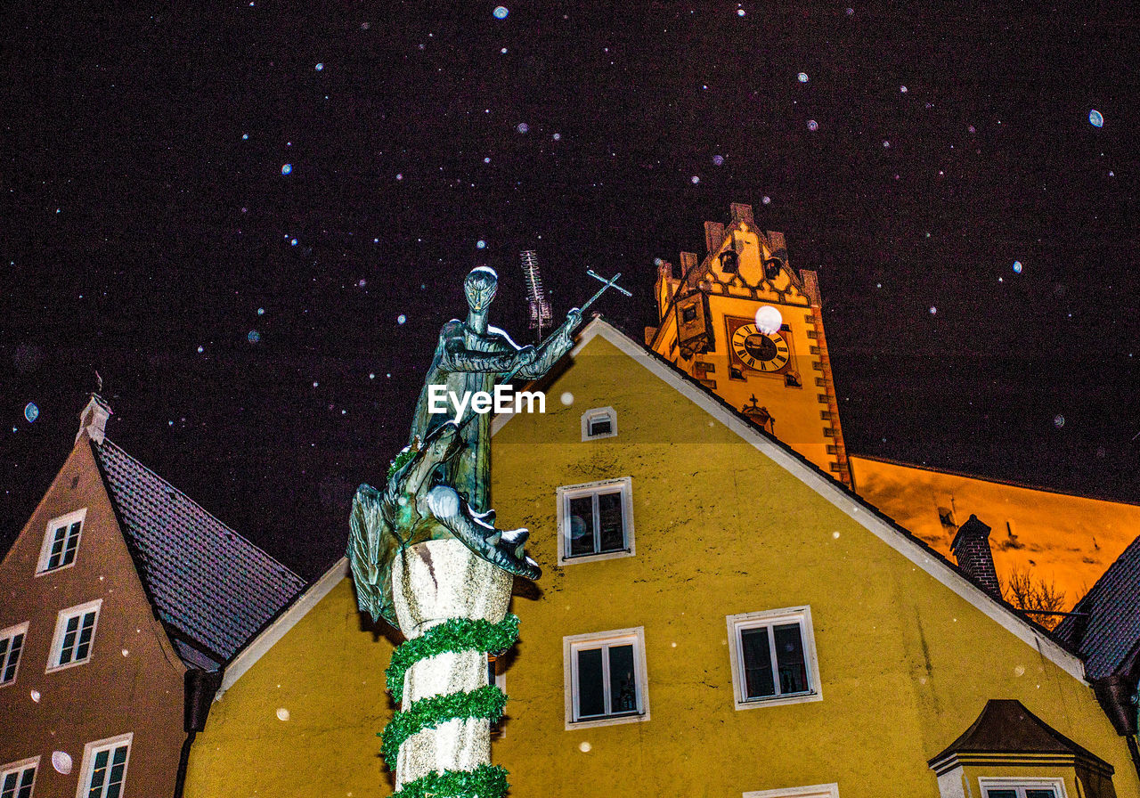 HIGH ANGLE VIEW OF ILLUMINATED OUTSIDE BUILDING AGAINST SKY AT NIGHT