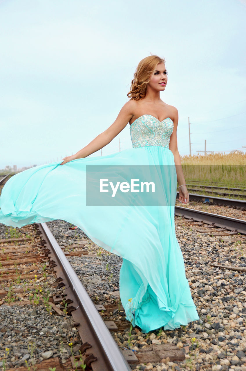 Full length of woman standing on railroad track