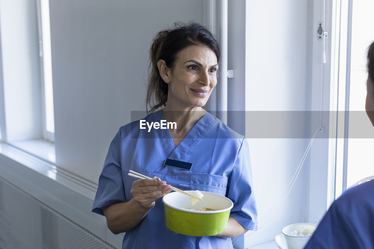 Nurse eating asian take-out food