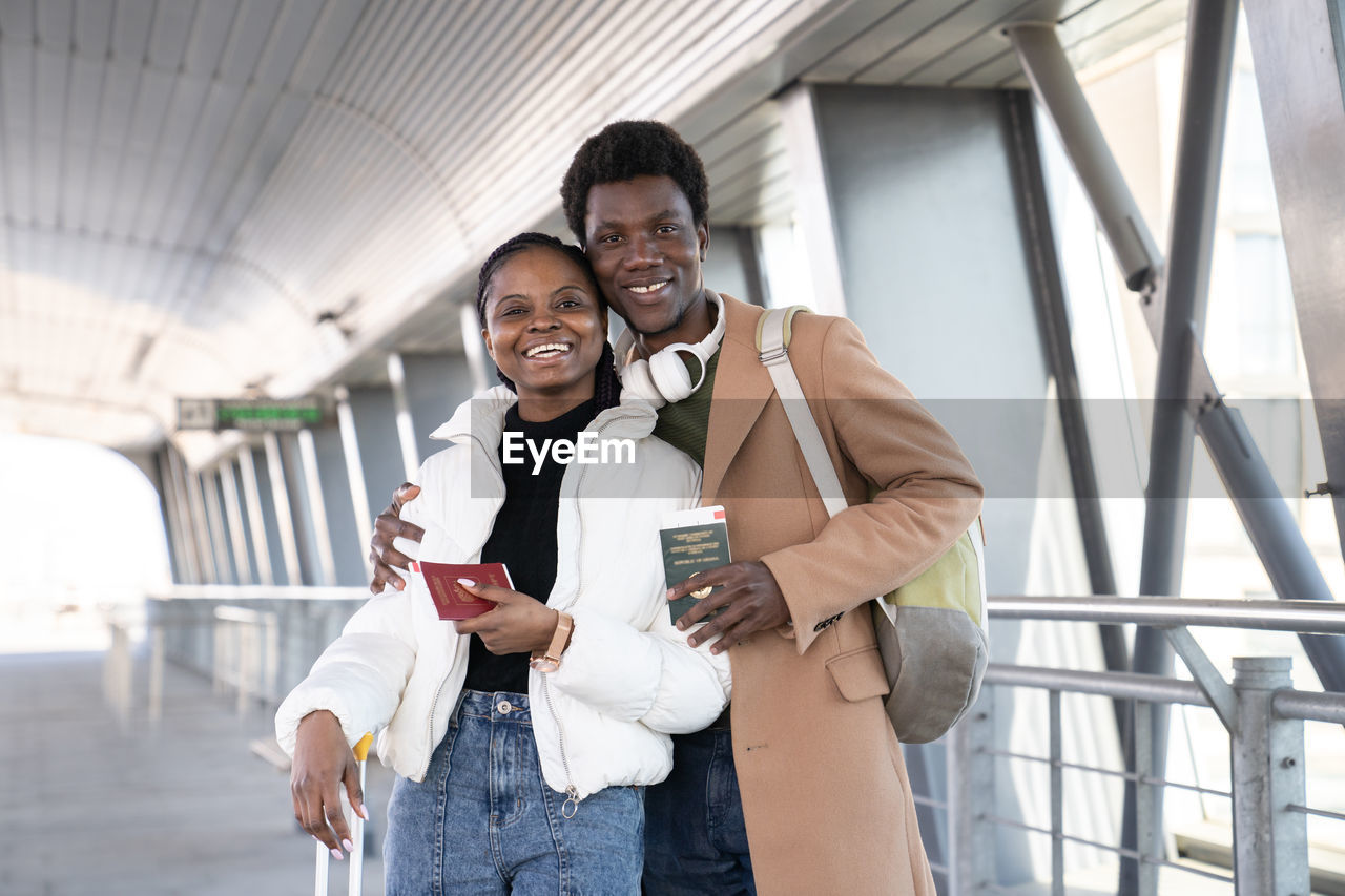 Portrait of smiling couple standing at airport