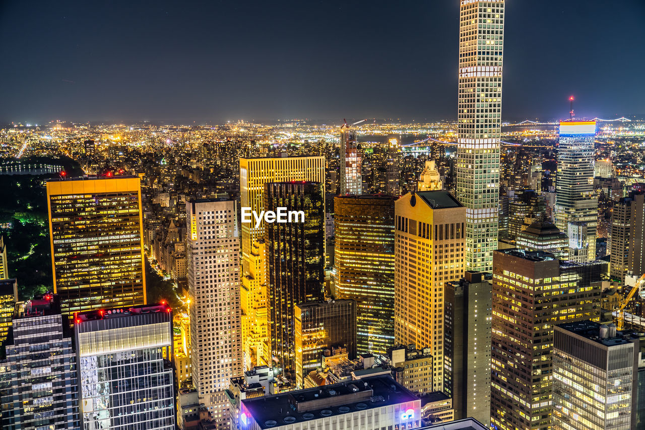 high angle view of illuminated buildings in city at night