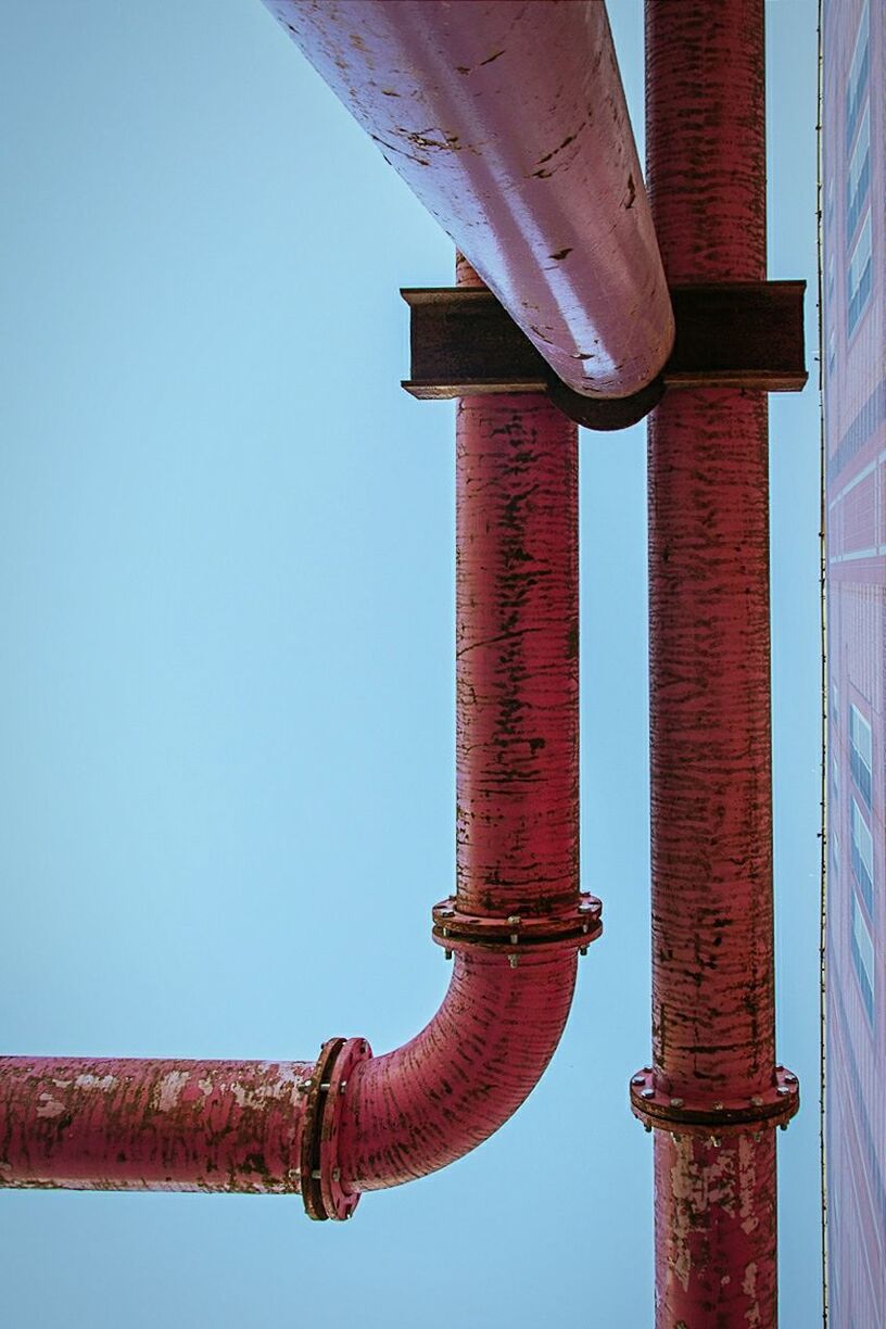 Low angle view of red pipe against clear sky