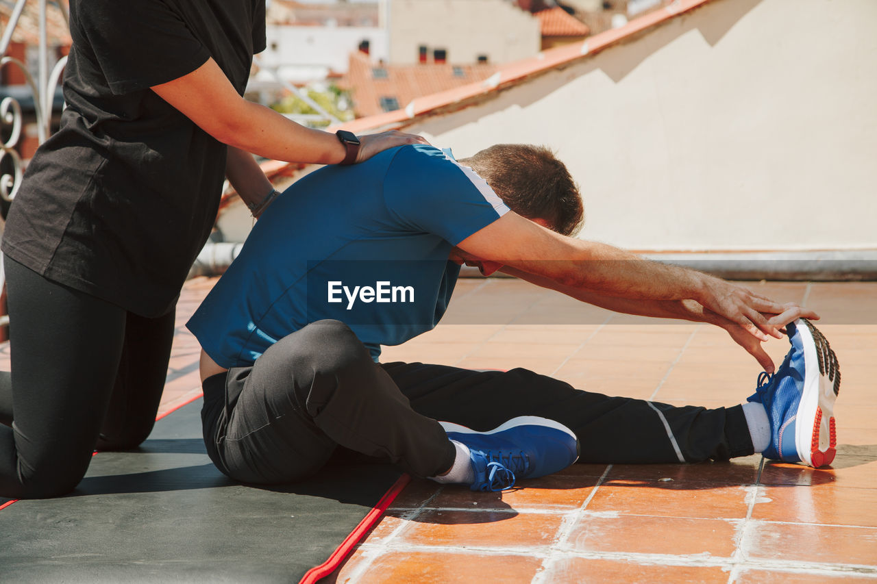 A couple exercising on their rooftop. training at home. 