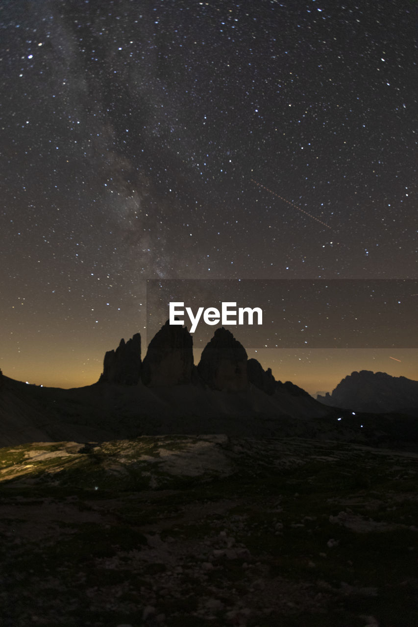 Scenic view of land against sky at night