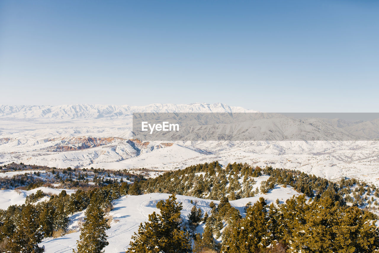 Panorama of the tien shan mountains covered with snow in sunny weather. winter landscape 