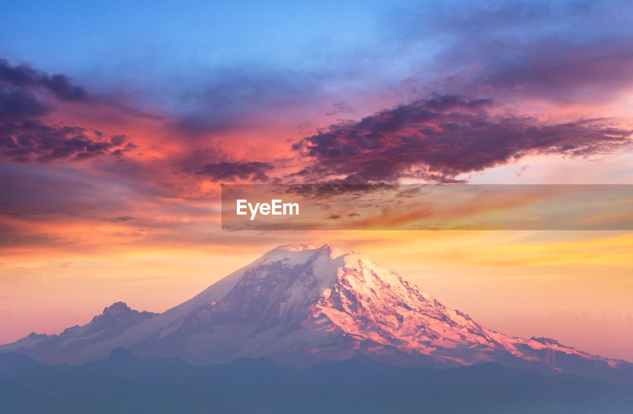 SCENIC VIEW OF SNOWCAPPED MOUNTAINS DURING SUNSET