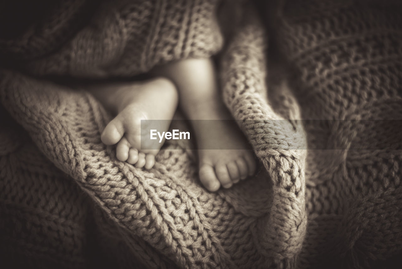 Low section of baby feet on knitted textile