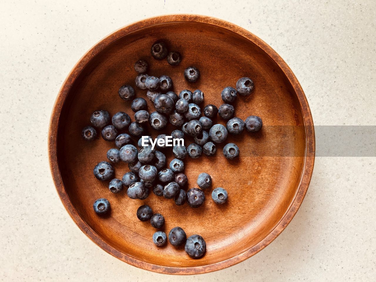  blueberries, scatter pattern, wooden bowl. fresh, colourful, juicy, sweet, nutritious, summer fruit.