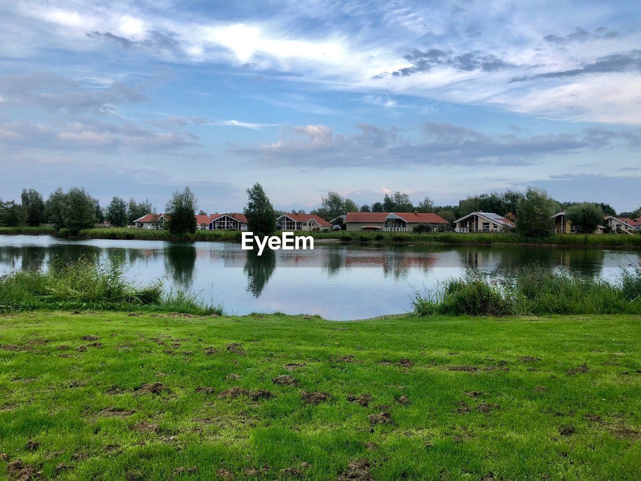 SCENIC VIEW OF LAKE WITH TREES AGAINST SKY