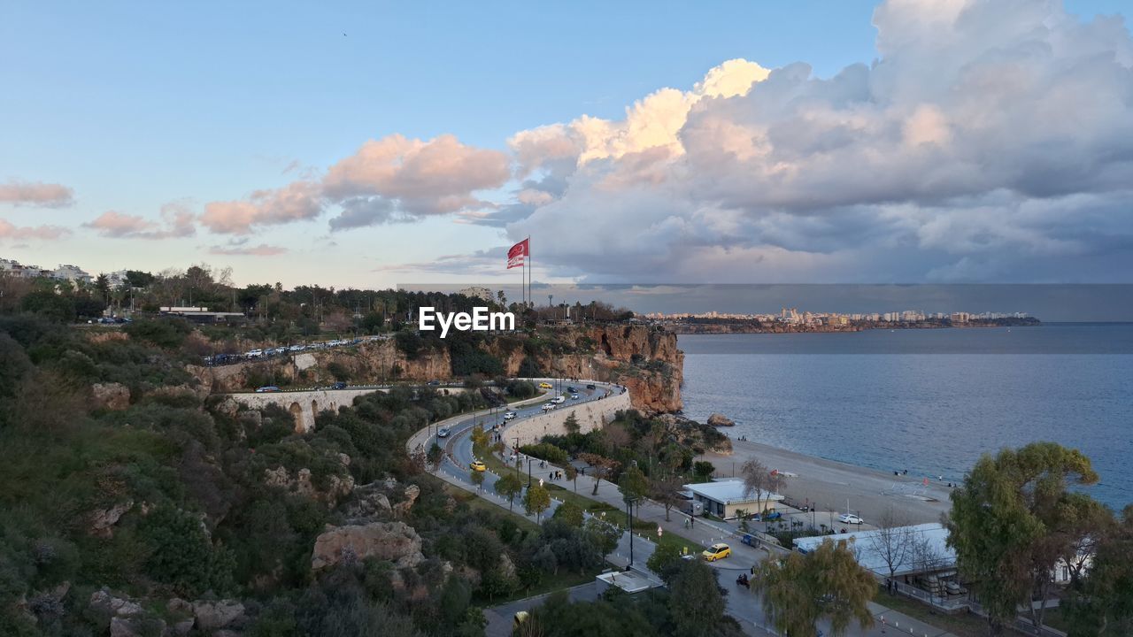 sky, coast, water, cloud, architecture, sea, nature, built structure, building exterior, city, travel destinations, travel, land, aerial photography, beach, horizon, environment, bay, transportation, flag, outdoors, high angle view, no people, building, shore, day, tourism, ocean, tree, plant, landscape, scenics - nature, blue, cityscape, vacation, coastline, beauty in nature, mode of transportation