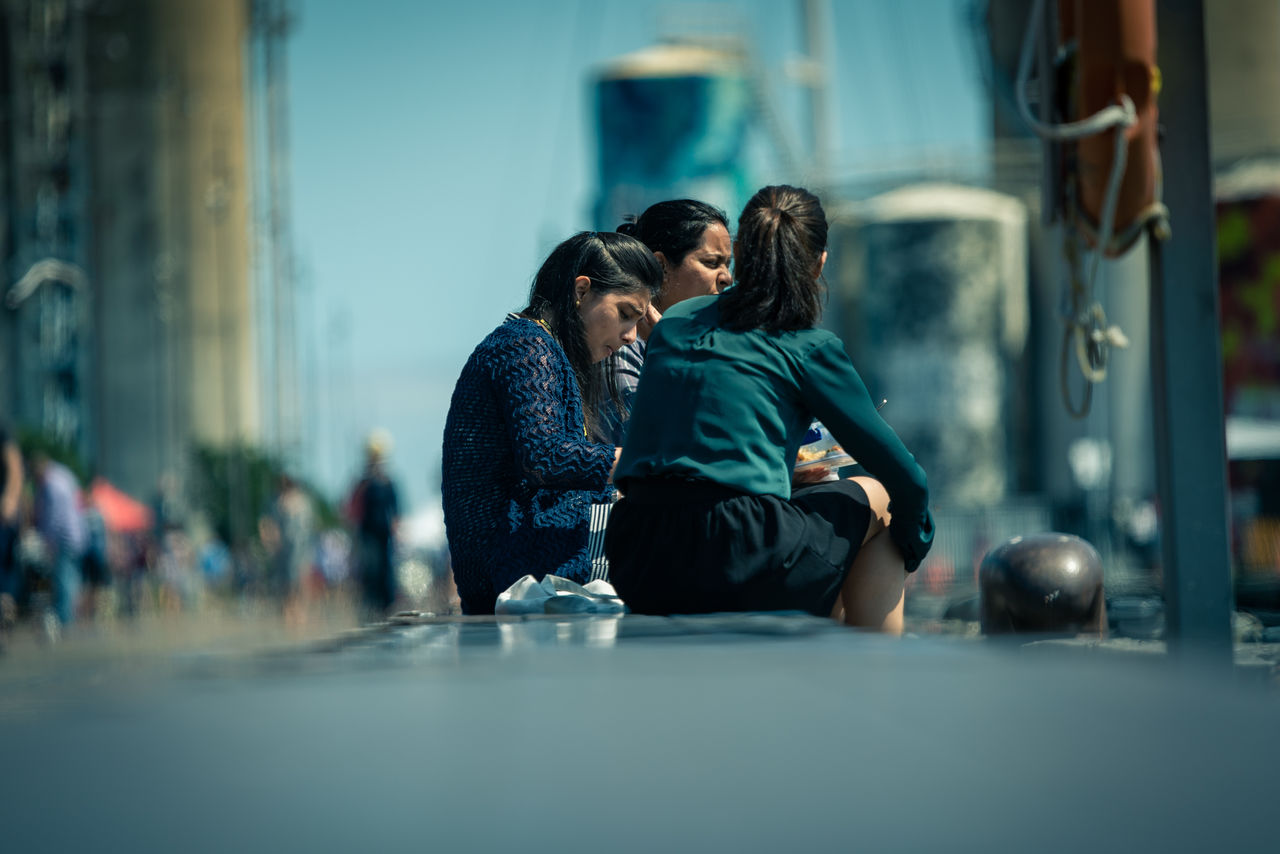 YOUNG COUPLE SITTING IN A ROW