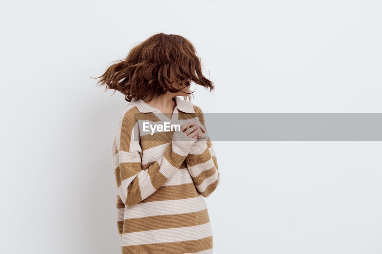 rear view of young woman against white background