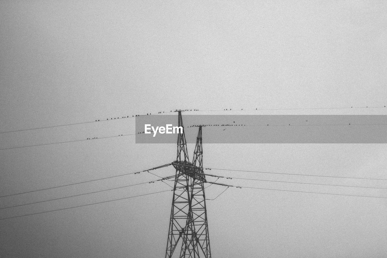 LOW ANGLE VIEW OF SILHOUETTE ELECTRICITY PYLON AGAINST SKY