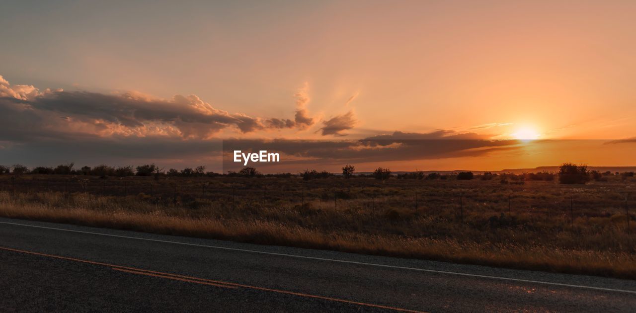 Scenic view of field against sky during sunset