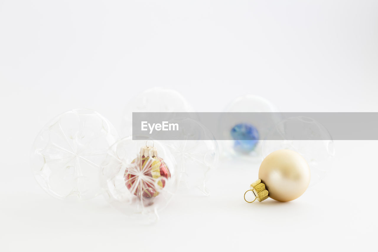 Beautiful decorative transparent, red and blue christmas glass balls on white background