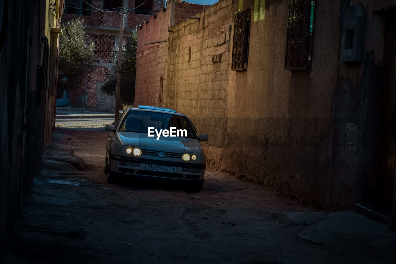 CAR ON STREET AGAINST BUILDINGS