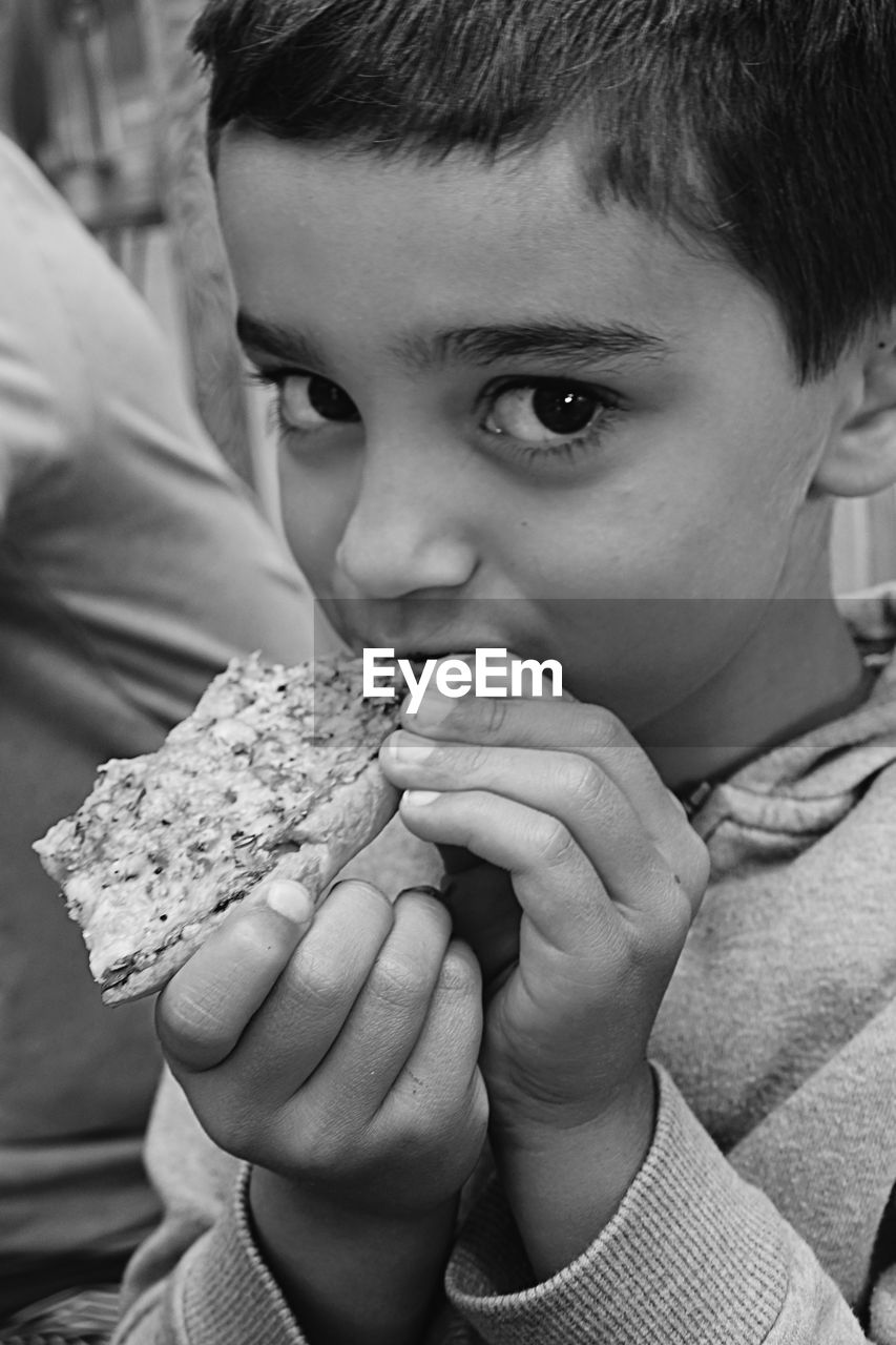 Close-up portrait of boy eating food