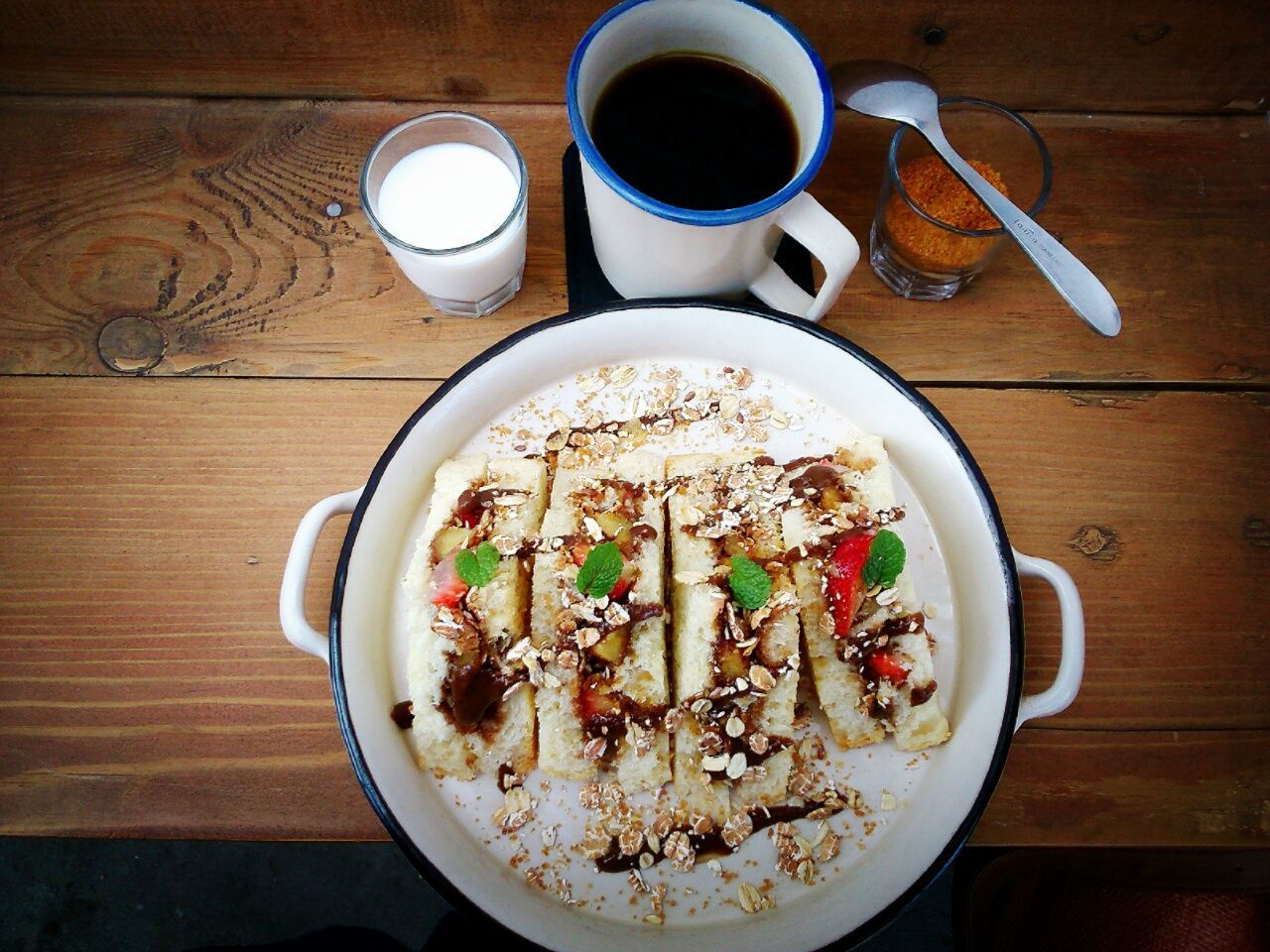 Directly above shot of fruit sandwich and fruits in milk by black coffee