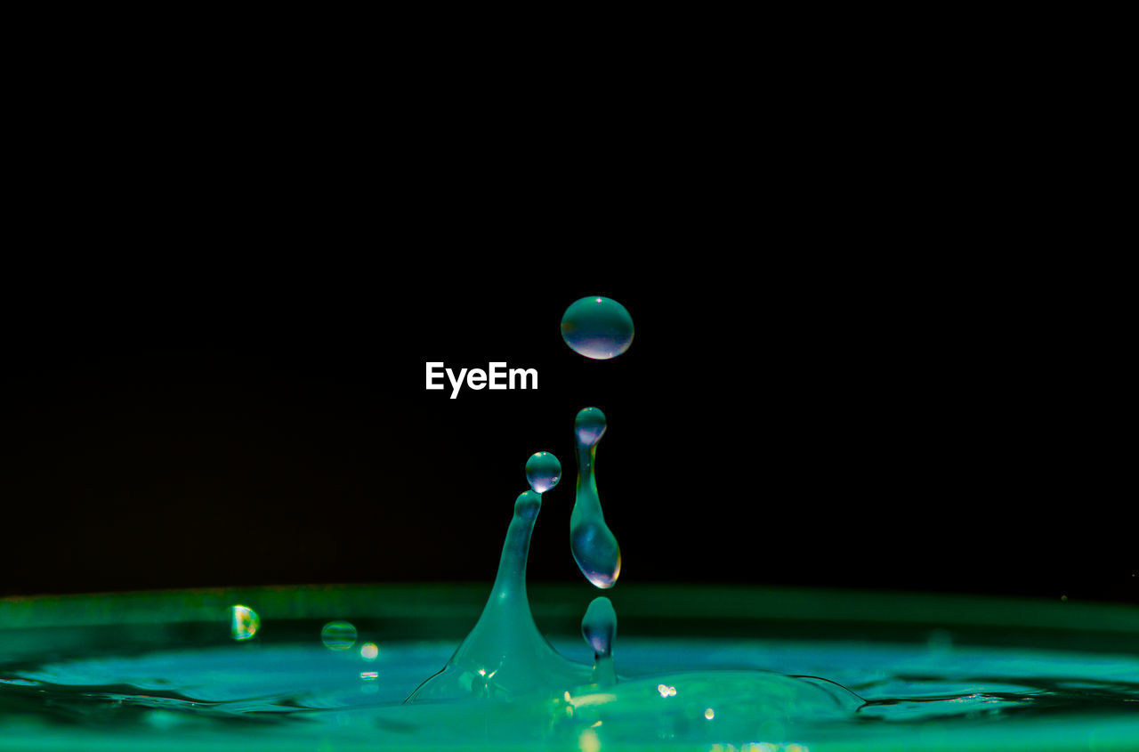 Close-up of water drop against black background