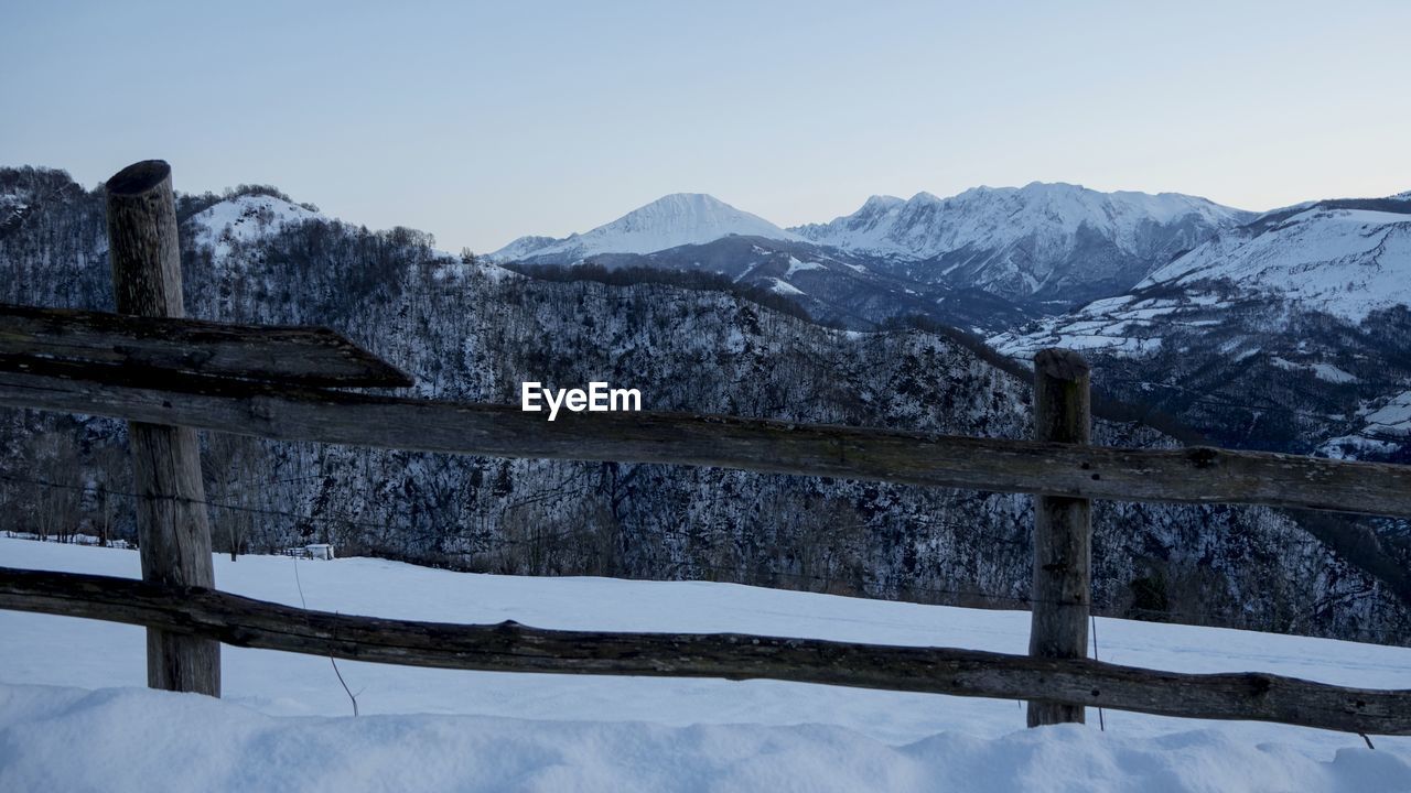 SNOW COVERED LANDSCAPE AGAINST SKY