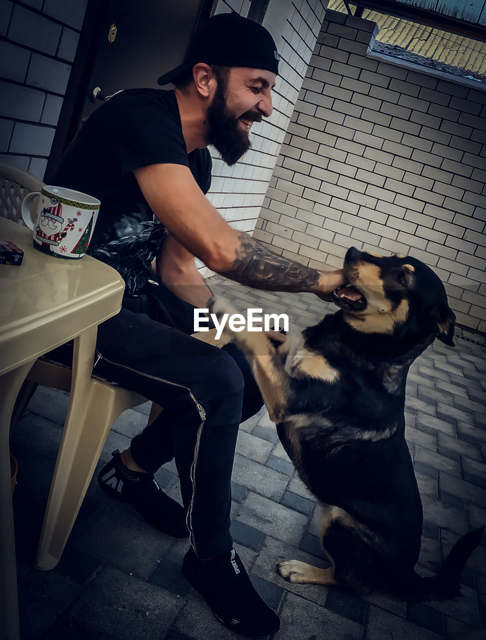 YOUNG MAN AND DOG SITTING IN OFFICE