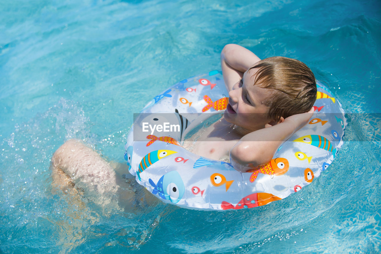 High angle view of boy swimming in pool