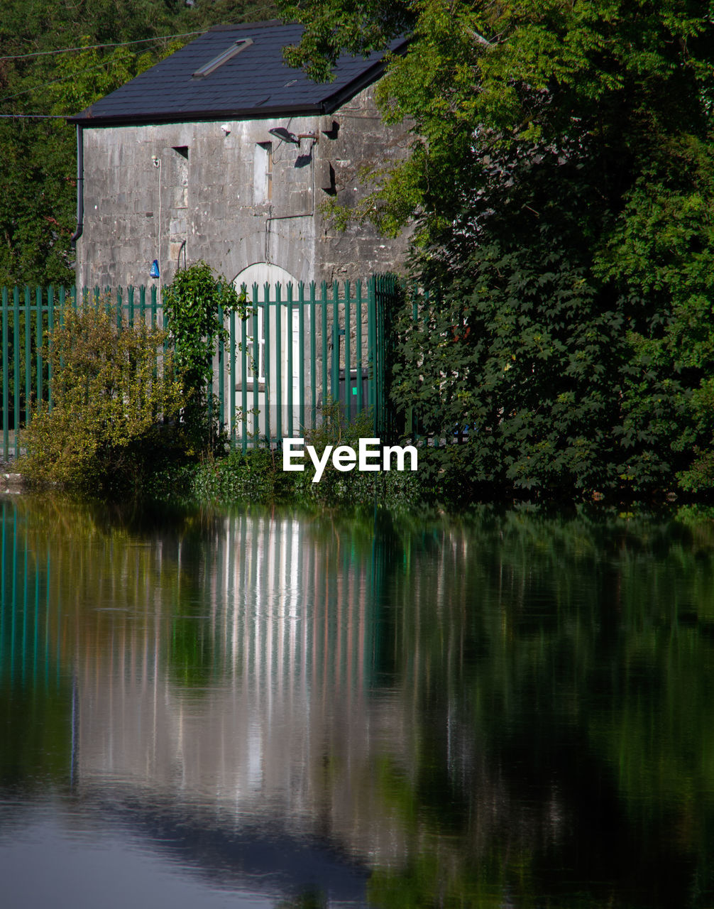 REFLECTION OF BUILDING ON LAKE