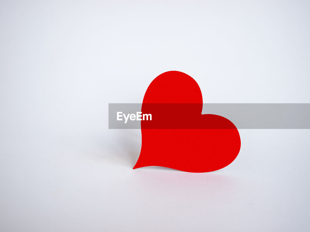 Close-up of red heart shape against white background